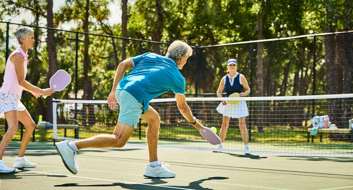 A group of seniors playing pickleball. 