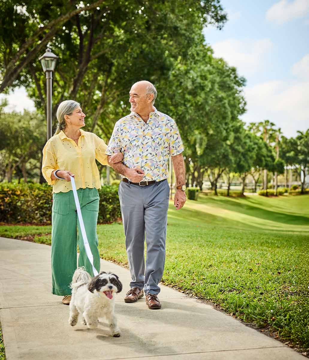 A couple walking their dog.