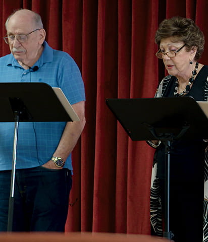 Lakeside Village residents read on stage