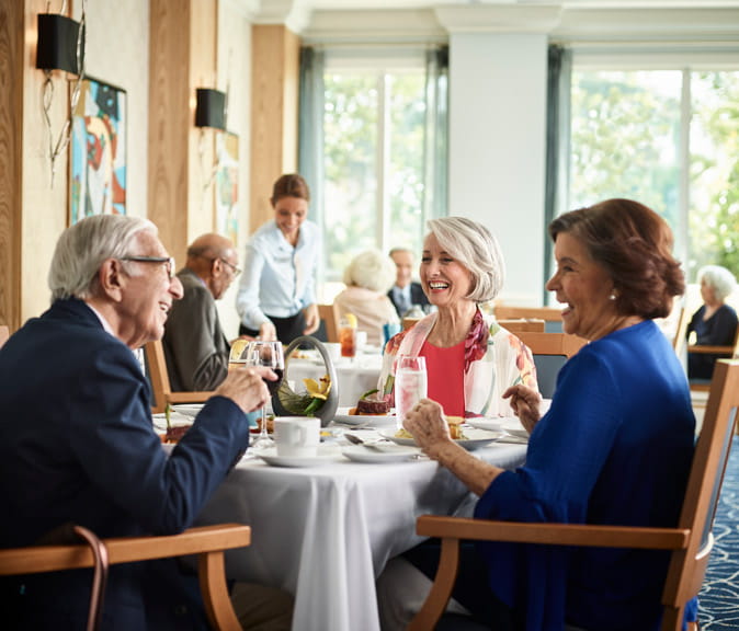 Three people enjoy a meal together at Vi at Aventura.