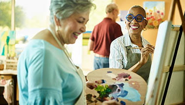 People painting on a easel in a art studio 