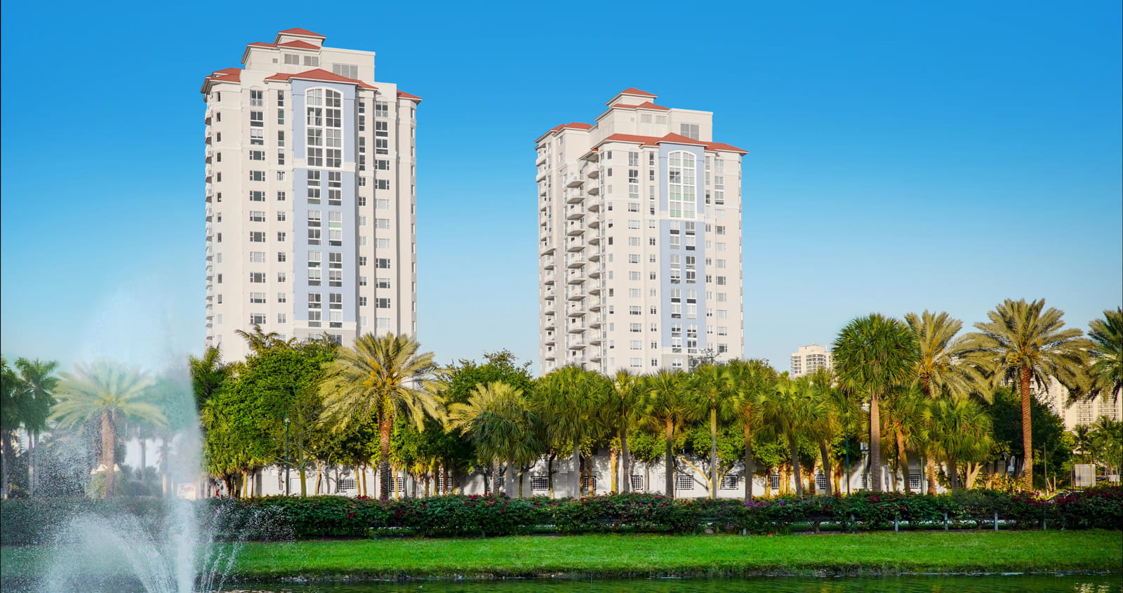 A view of the Vi at Aventura buildings from across a small lake.