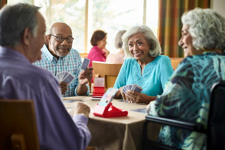 Four people play bridge at Vi at Aventura.