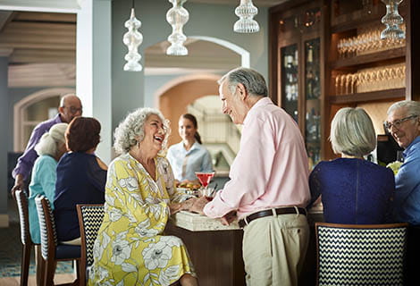 A man and woman share a laugh at happy hour