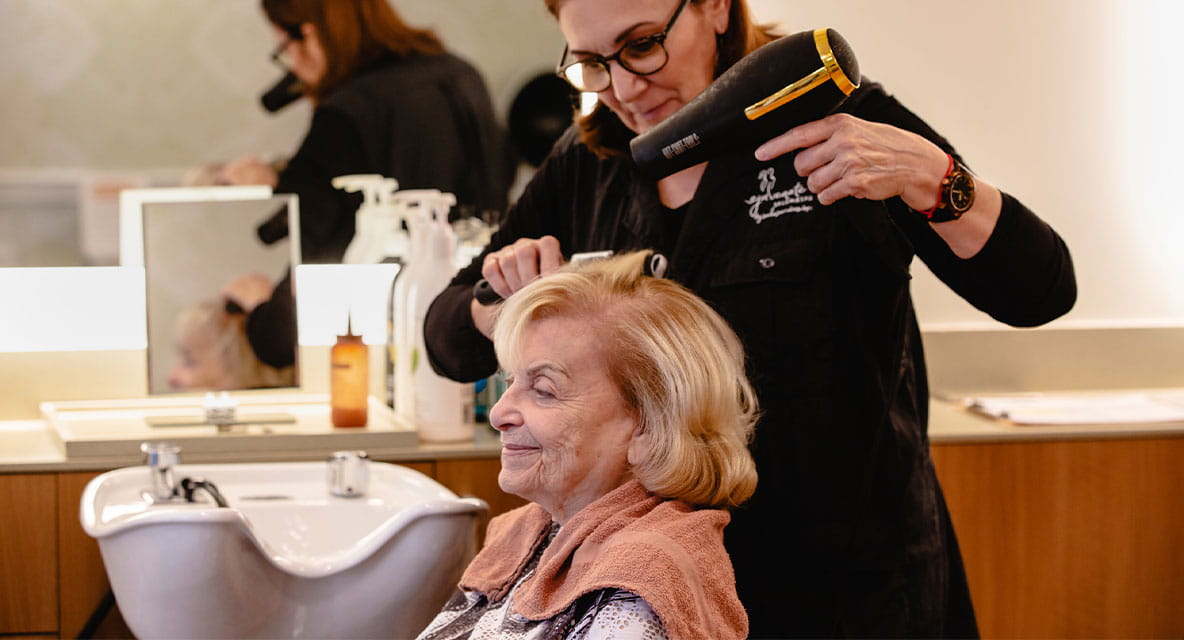 A women getting her hair done. 