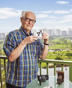 Resident Julian Greenspan holds one of his prized cameras.