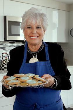 Susan Shovers, who hosts "Cooking with Bubbe" at Vi at Aventura, holds a plate of cookies.