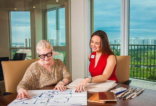 A future resident reviews her floor plan with a staff member.