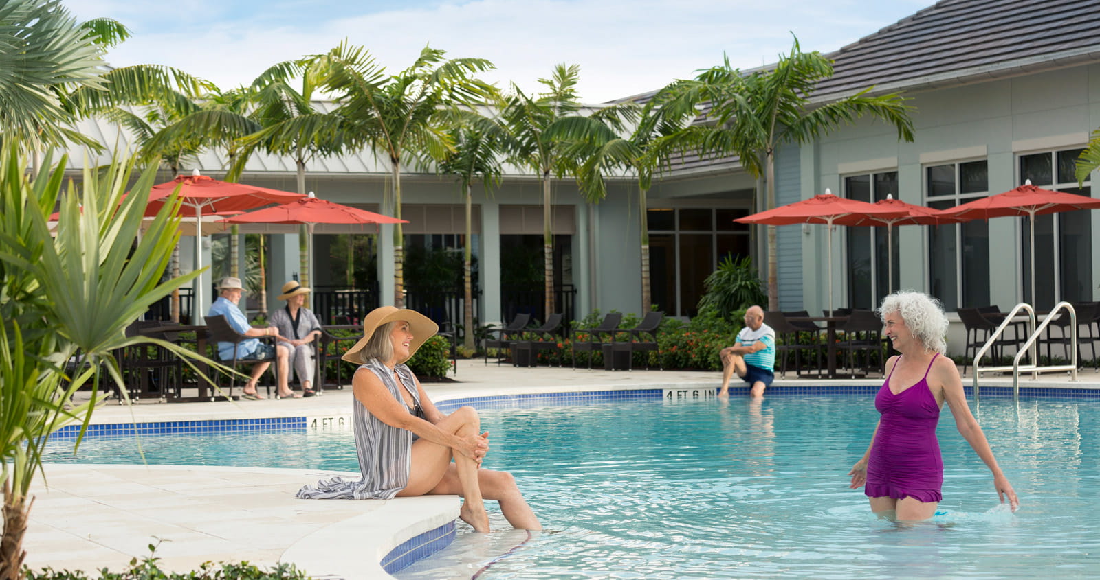 Residents lounge around a pool at Vi at Bentley Village.