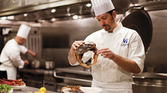 Chef La Russa handles a crab in the kitchen