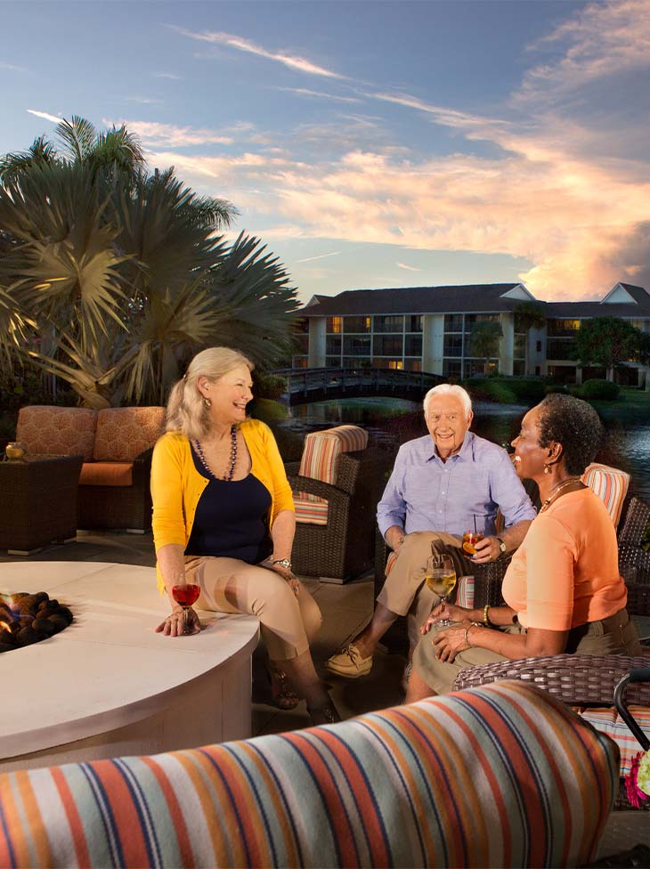 People sitting around a firepit. 