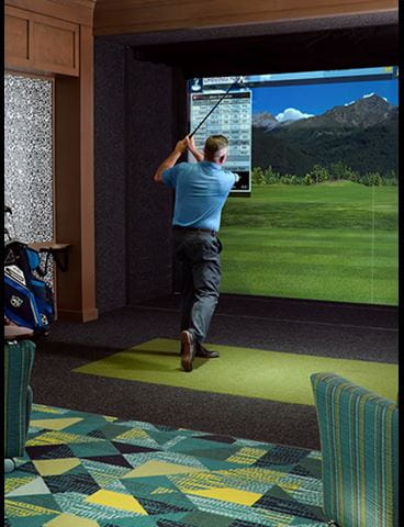 A man uses one of the golf simulators at Vi at Bentley Village.