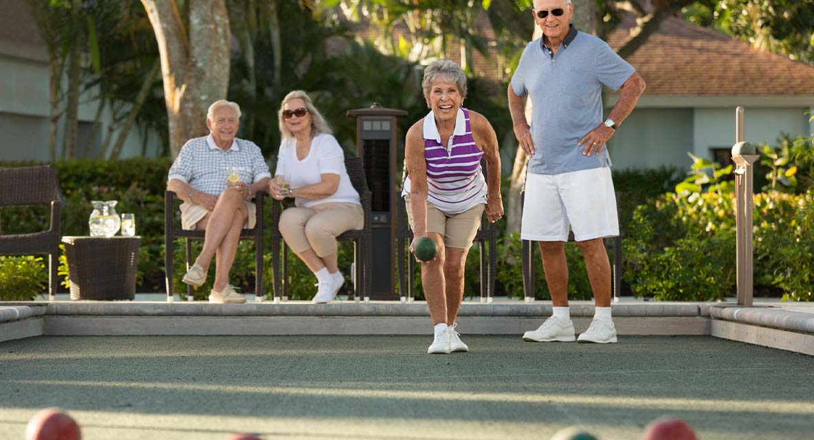 A group of people playing bocce. 