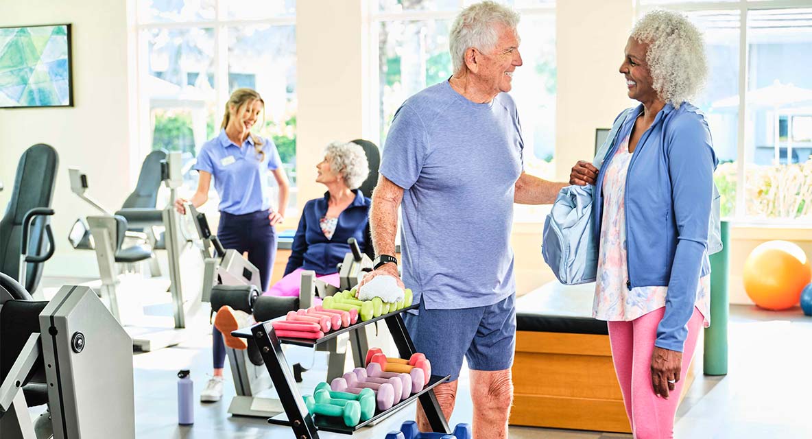 Two people having a conversation at the gym. 