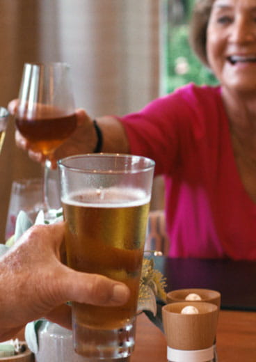 Friends raise a glass in a Vi at Bentley Village dining room.