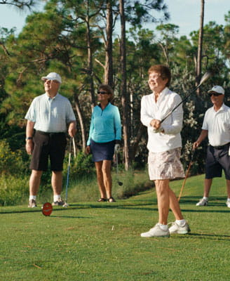 Two couples golf at Vi at Bentley Village.