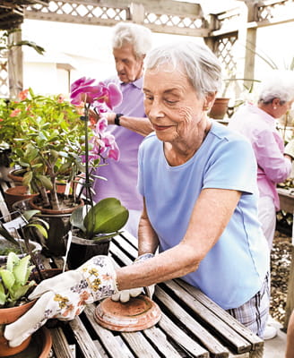 Residents pot plants in the Plant House.
