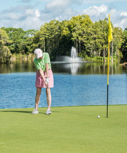 A resident golfs at Vi at Bentley Village.