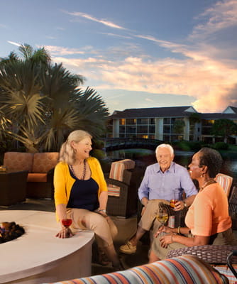 Seniors socialize at near the fire pit.