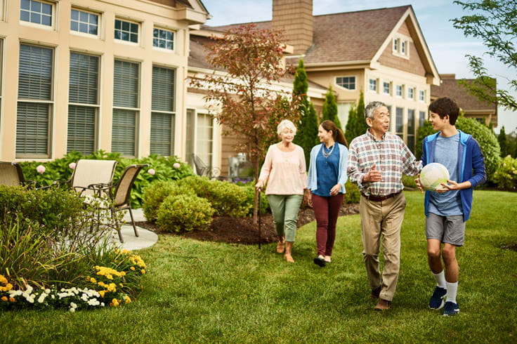 A multigenerational family walks at Vi at The Glen.