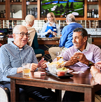 A group of seniors hanging out at the community bar. 