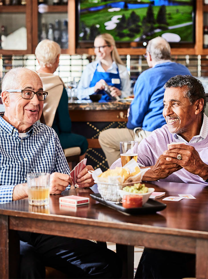 A group of seniors hanging out at the community bar.