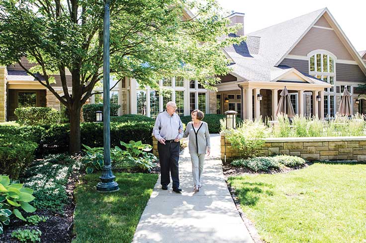 A couple walking at Vi at The Glen.