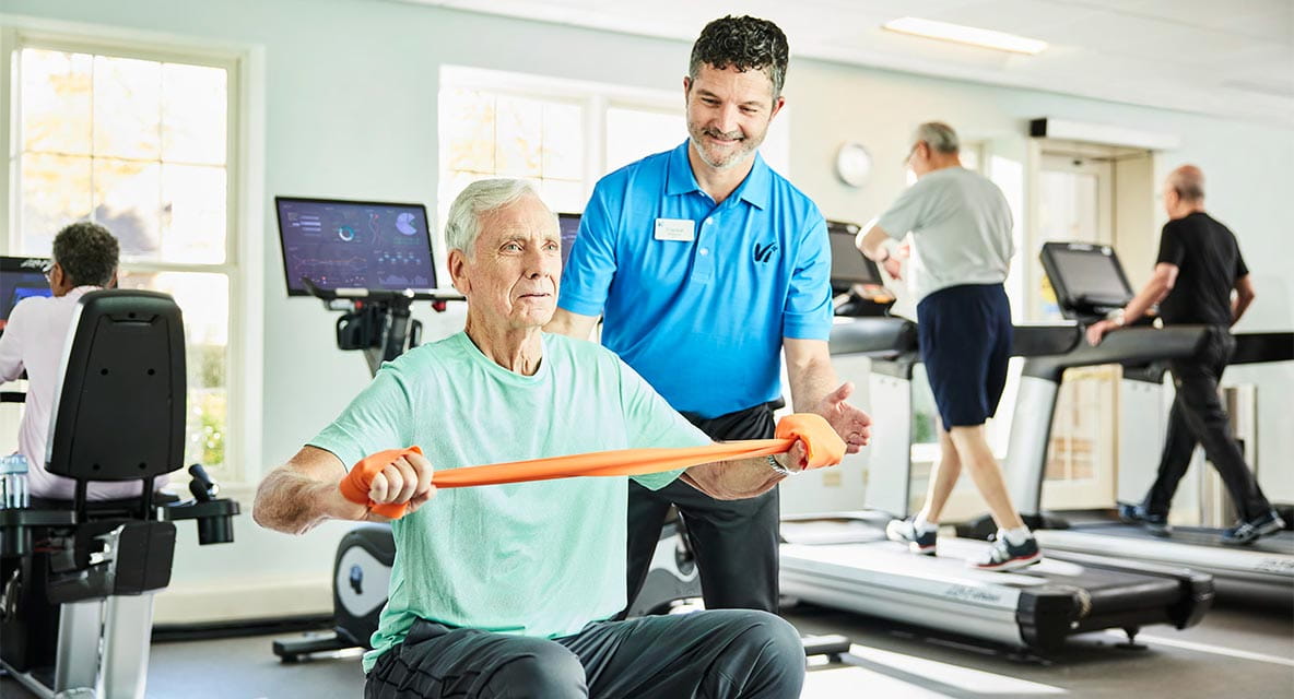 Man working out with trainer at Vi at The Glen gym. 