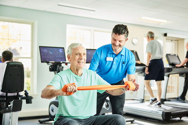 A man works out with a trainer at Vi at The Glen.