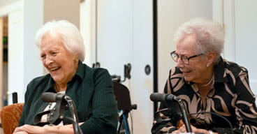 Two women laugh together.