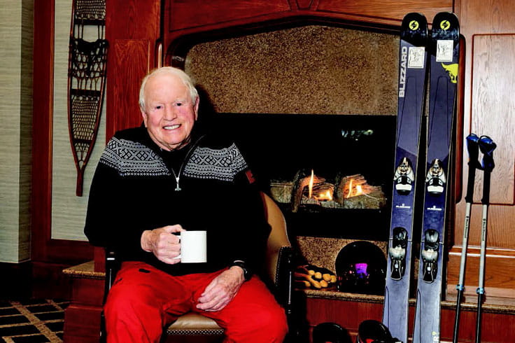 Mead Montgomery sits in front of the fireplace.
