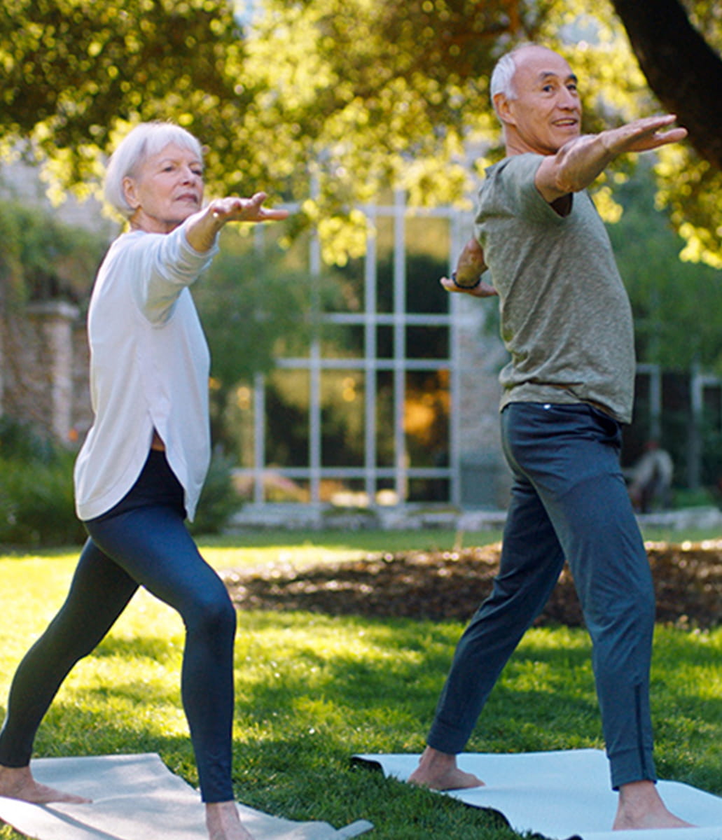Two people doing outdoor yoga