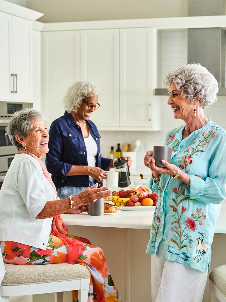 Women hanging out in the kitchen.