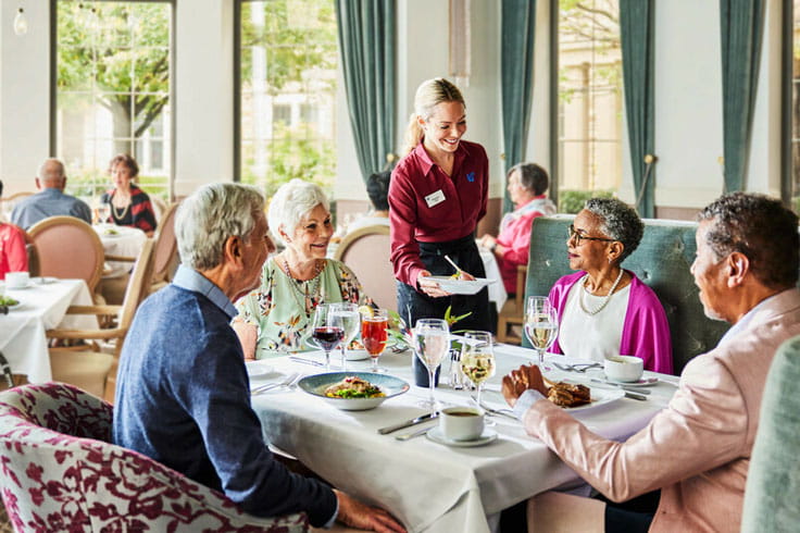 A server waits on a table of residents.