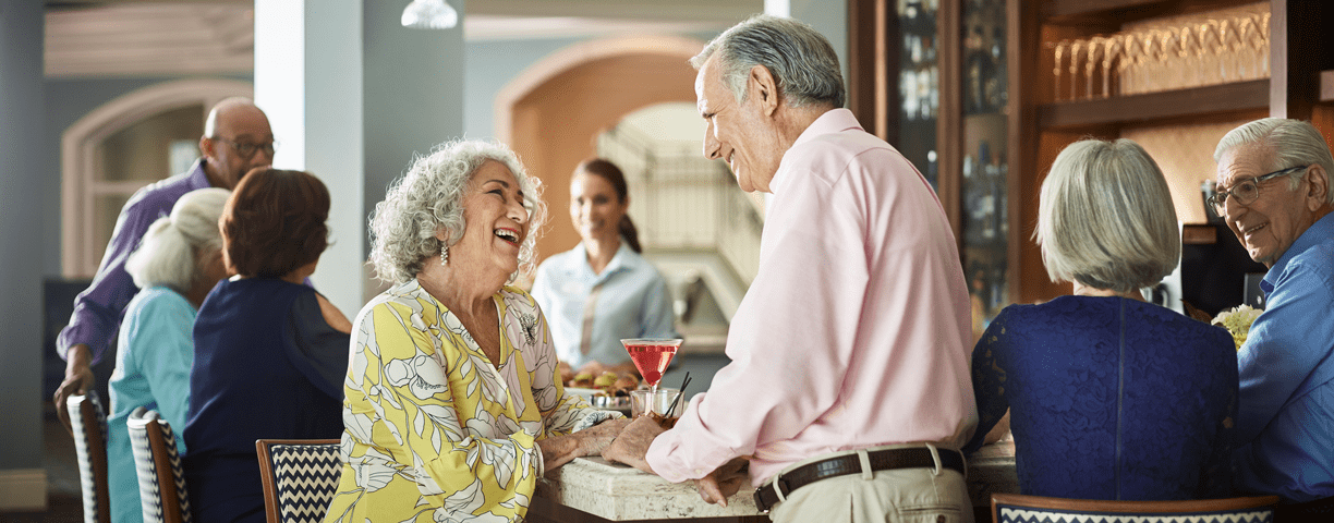 A man and woman chat at the bar at Vi at Aventura.