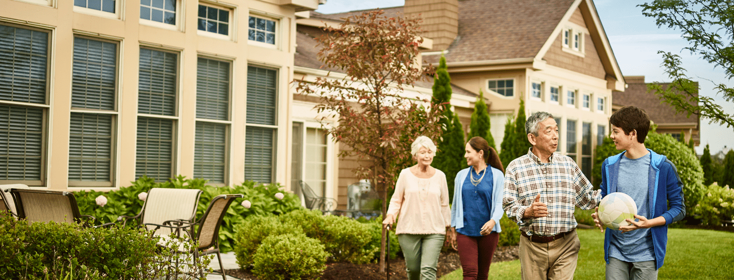 A multigenerational family walks outside.