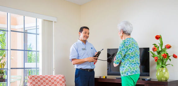 A maintenance staff member visits a resident's home.