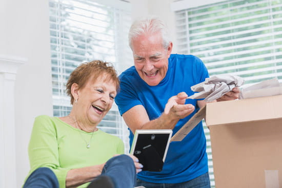 A couple laughs while packing up photos.