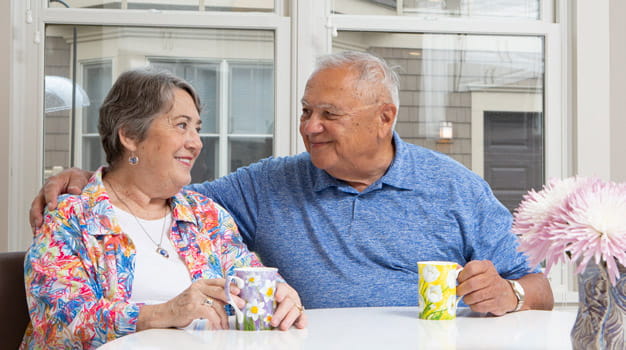 Ray and Joan Racelis smile in their villa.