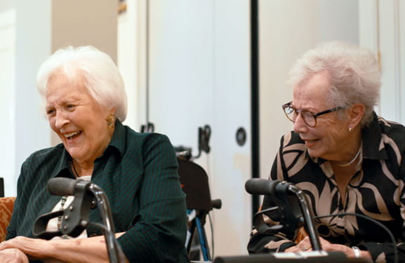 Women share a laugh during improv class.