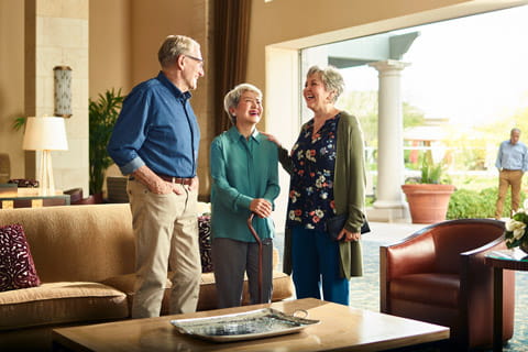 Residents laugh together in a lobby.