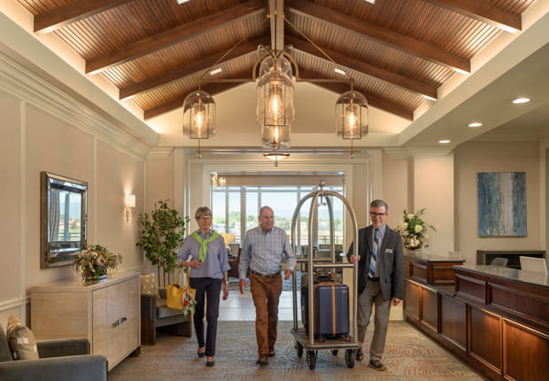 Two Vi at Highlands Ranch residents are helped with their luggage.