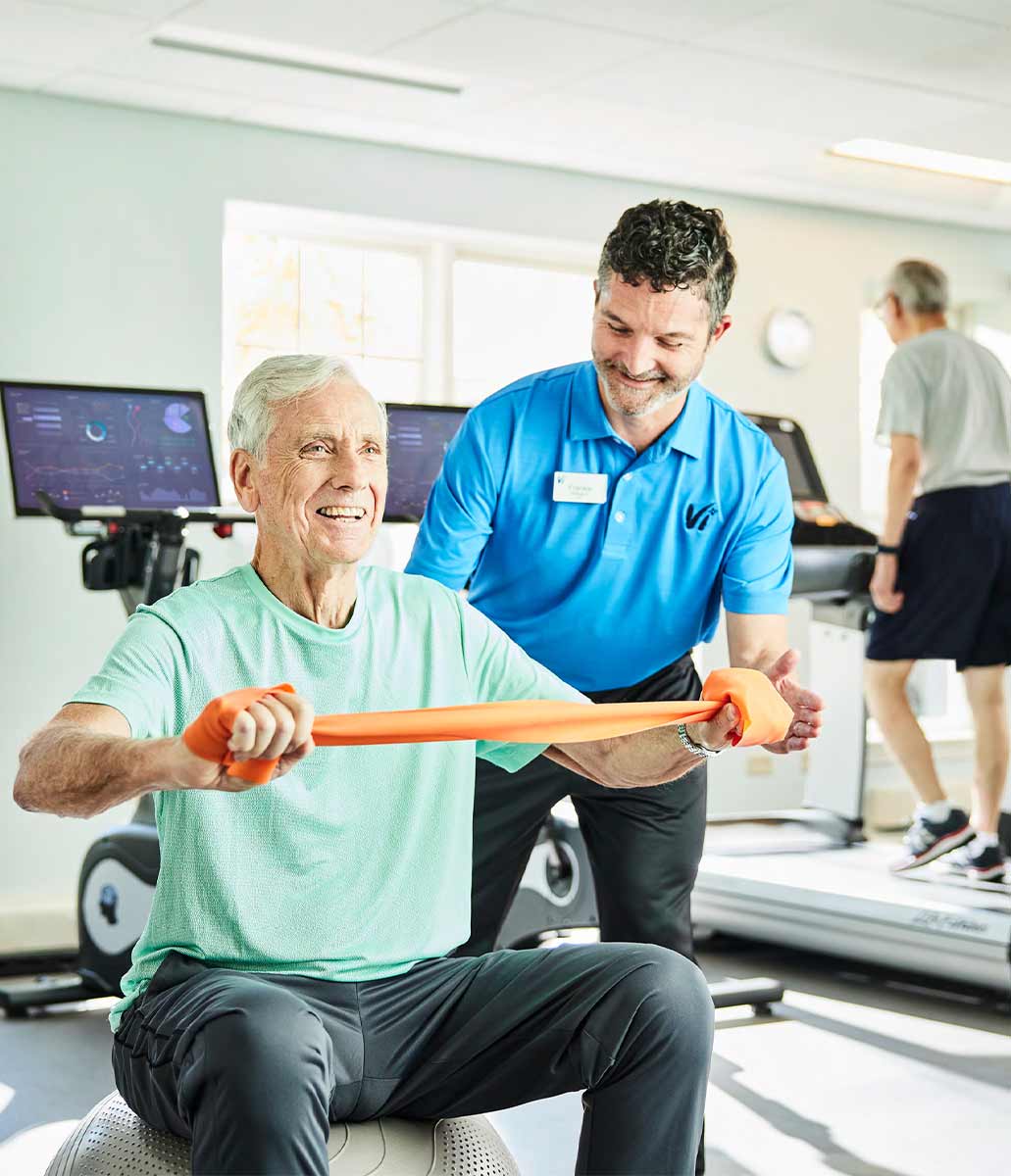 A man working out with a trainer. 