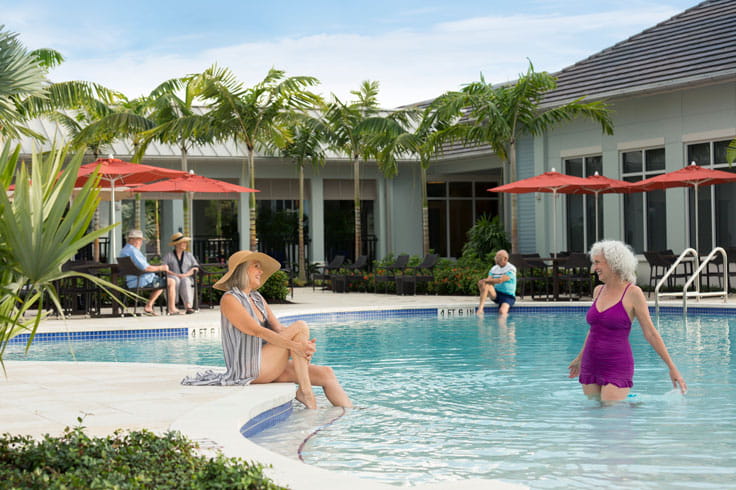 Women chat in the pool at Vi at Bentley Village.