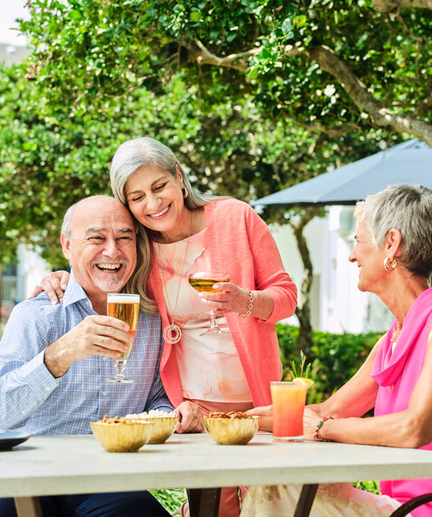 Friends enjoy drinks outside.